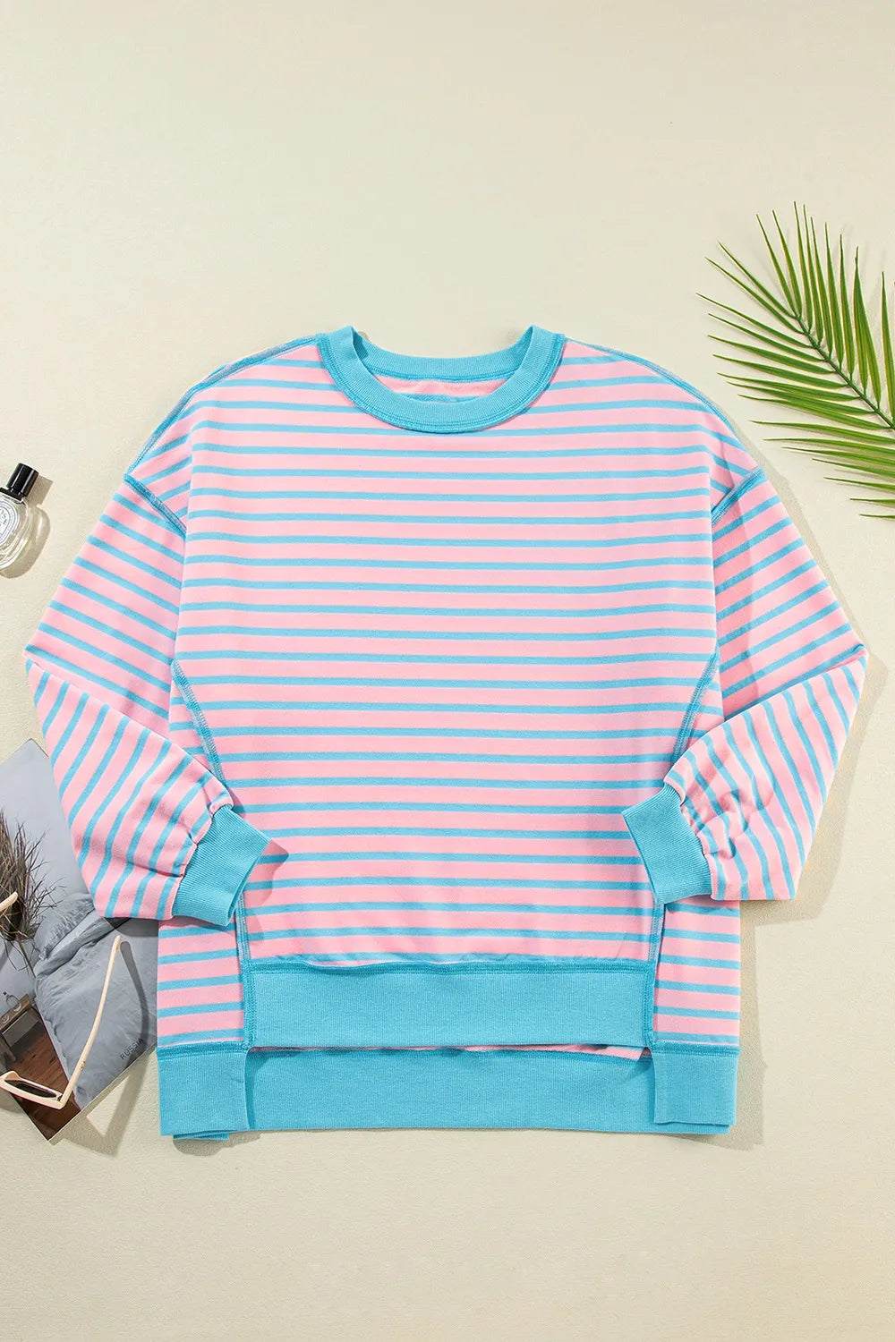 Pastel pink and light blue high-low striped long sleeve sweatshirt with turquoise trim