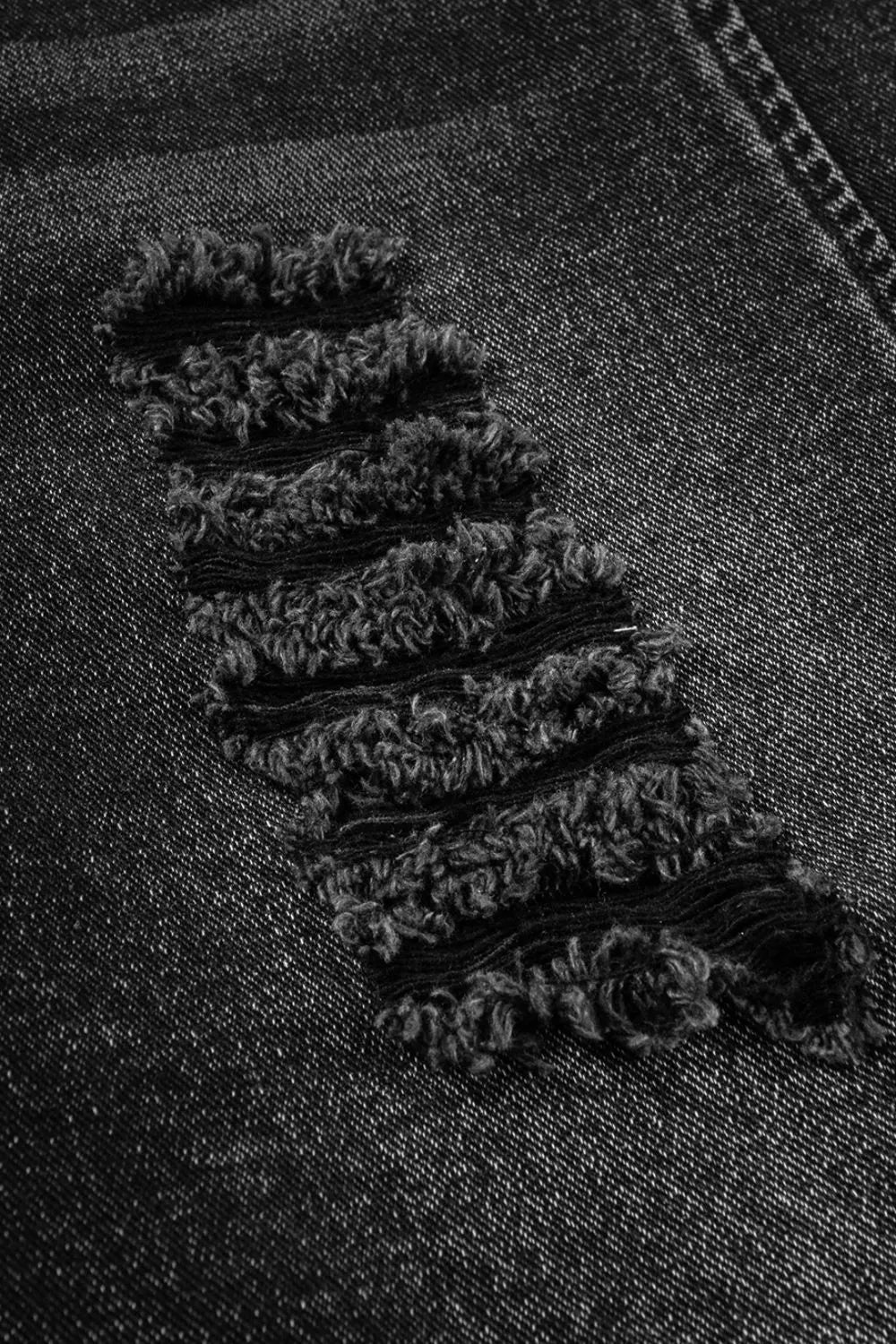 Distressed wide strap denim overalls with black frayed textured edges