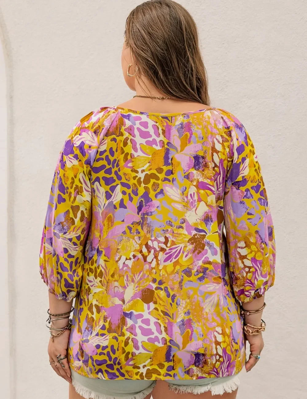 Plus size printed tie neck blouse in vibrant floral hues on sheer fabric