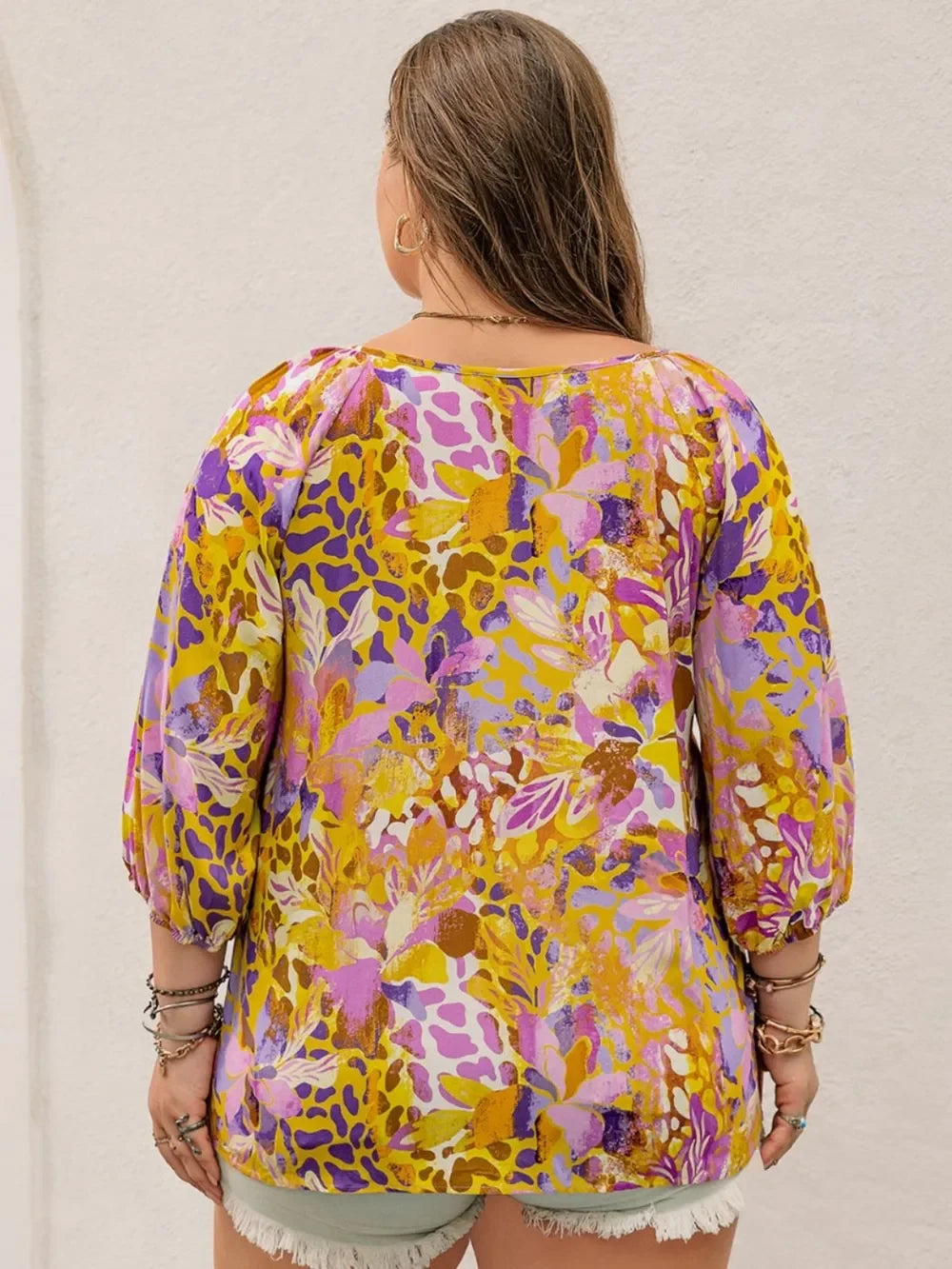 Plus size printed tie neck blouse in vibrant floral hues on sheer fabric