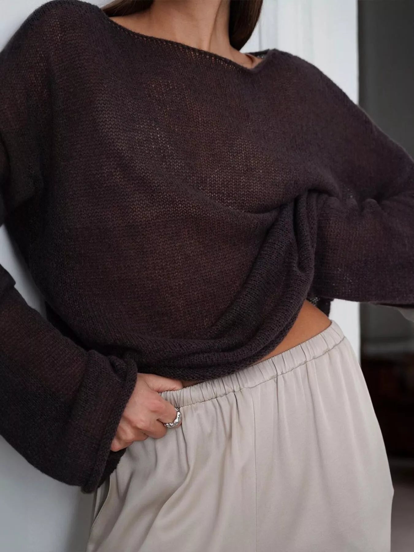 Boat neck dropped shoulder sweater in loose dark brown knit with sheer texture