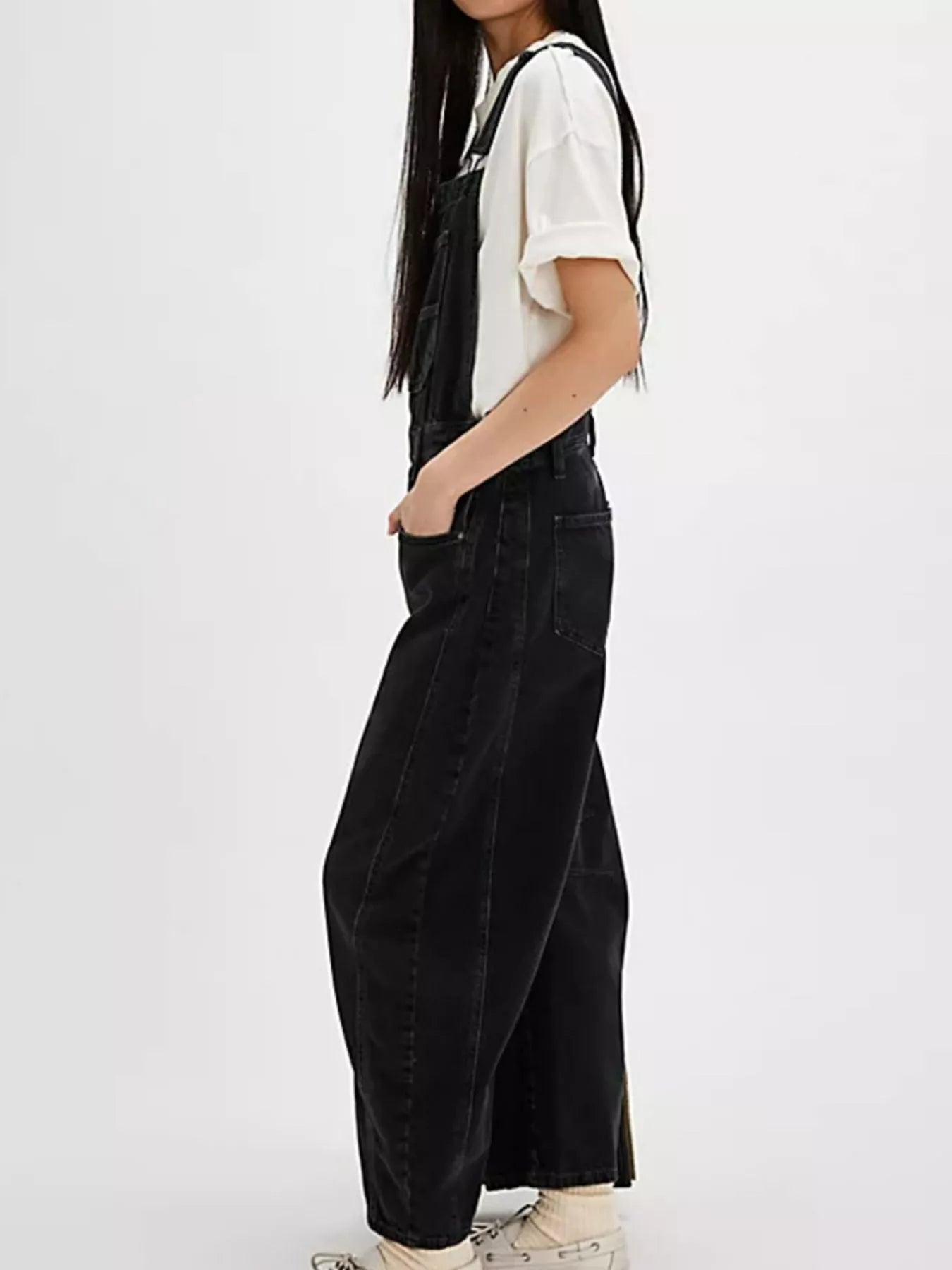 Black wide-leg denim overalls with wide straps, relaxed fit and visible stitching