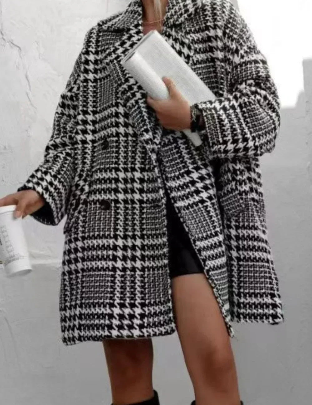 Black and white houndstooth collared long sleeve coat with oversized sleeves and pockets
