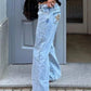 Light-wash denim flare jeans with leopard patch on back pocket