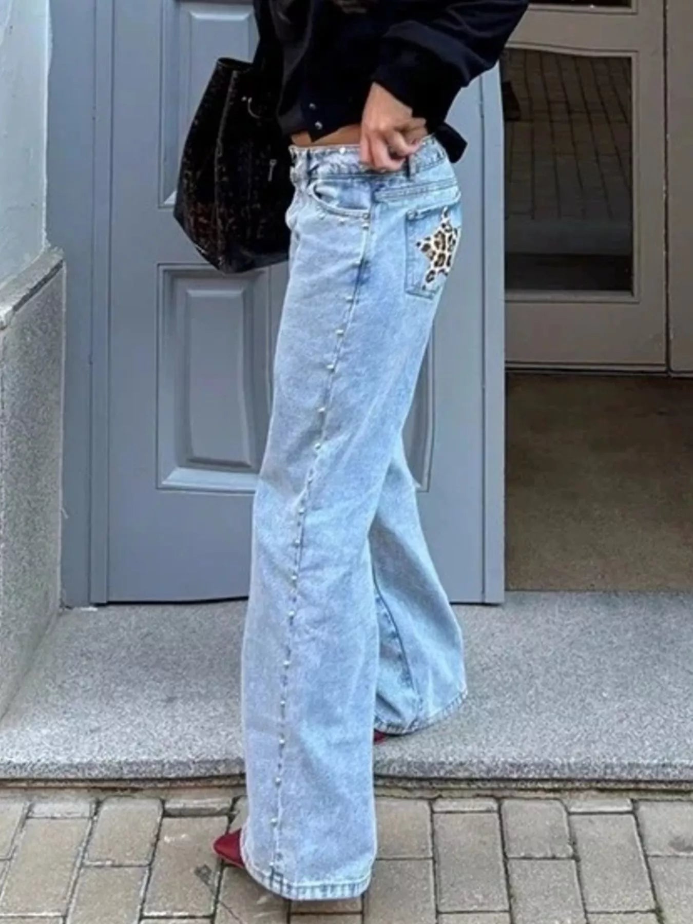 Light-wash denim flare jeans with leopard patch on back pocket