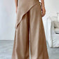 Daverri wrap-front wide-leg pants in tan with draped asymmetrical design