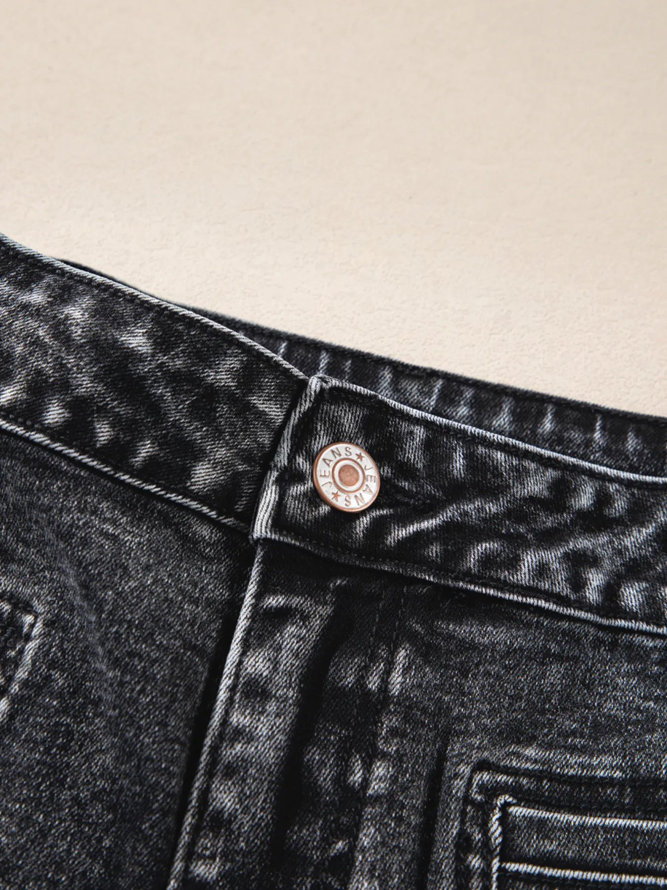 High-waisted wide leg washed black denim jeans with metallic lans button