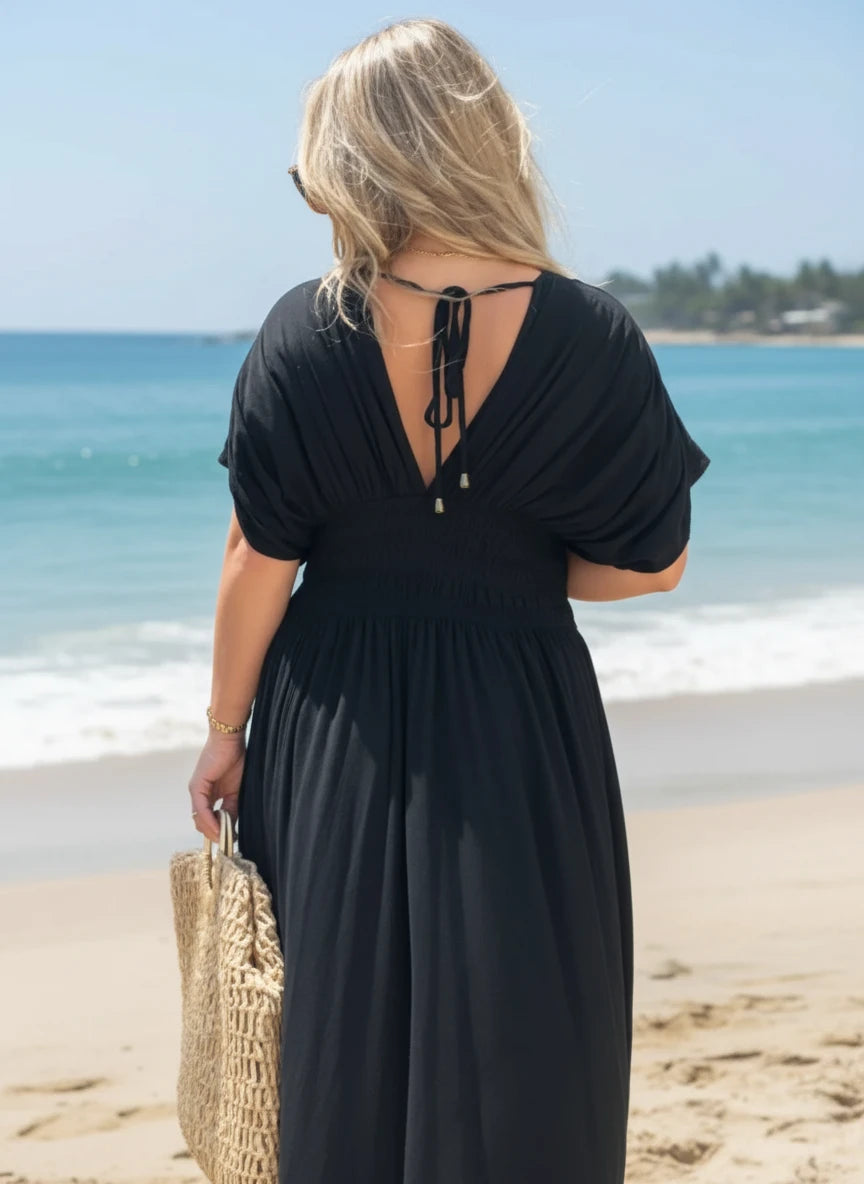 Black flowing Daverri Fashions maxi dress with deep V-neck, back tie, and side slit