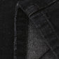 Distressed loose fit jeans in black denim with worn texture and seam stitching