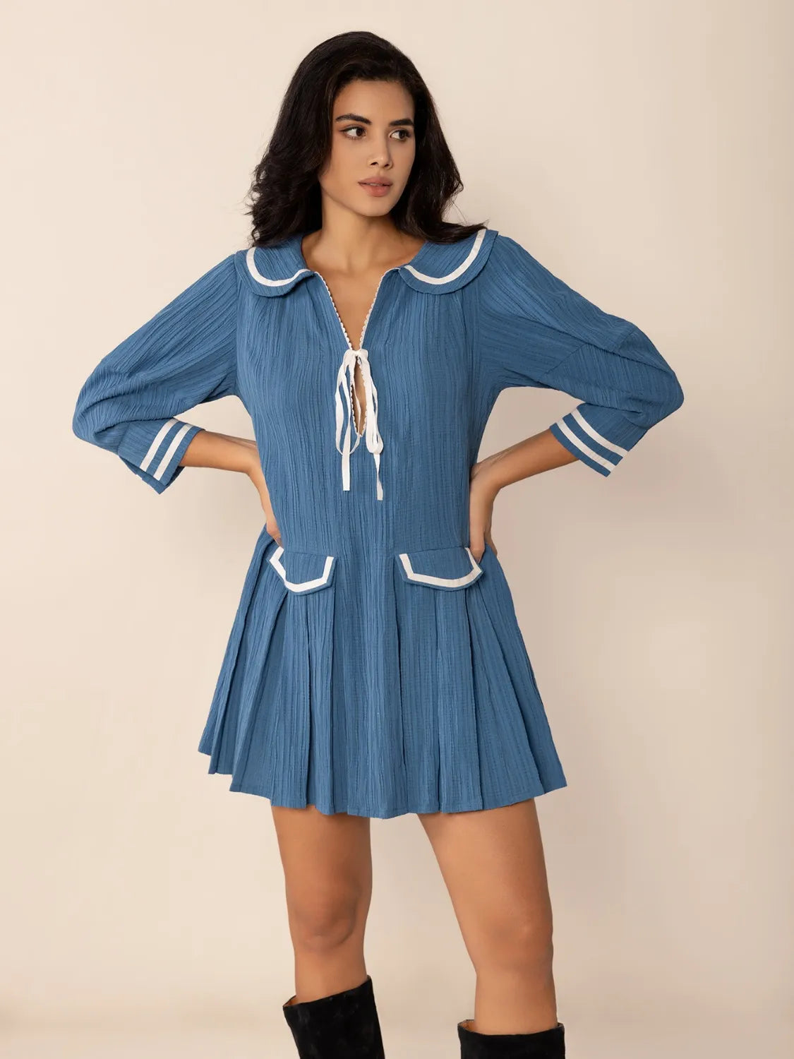 Blue pleated mini dress with Peter Pan collar, tie front, and sailor trim