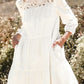 White 3/4 sleeve tiered mini dress with lace neckline detailing