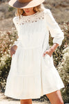 White 3/4 sleeve tiered mini dress with lace neckline detailing