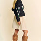 Black knit Davi & Dani floral cardigan with embroidered flowers on sleeves