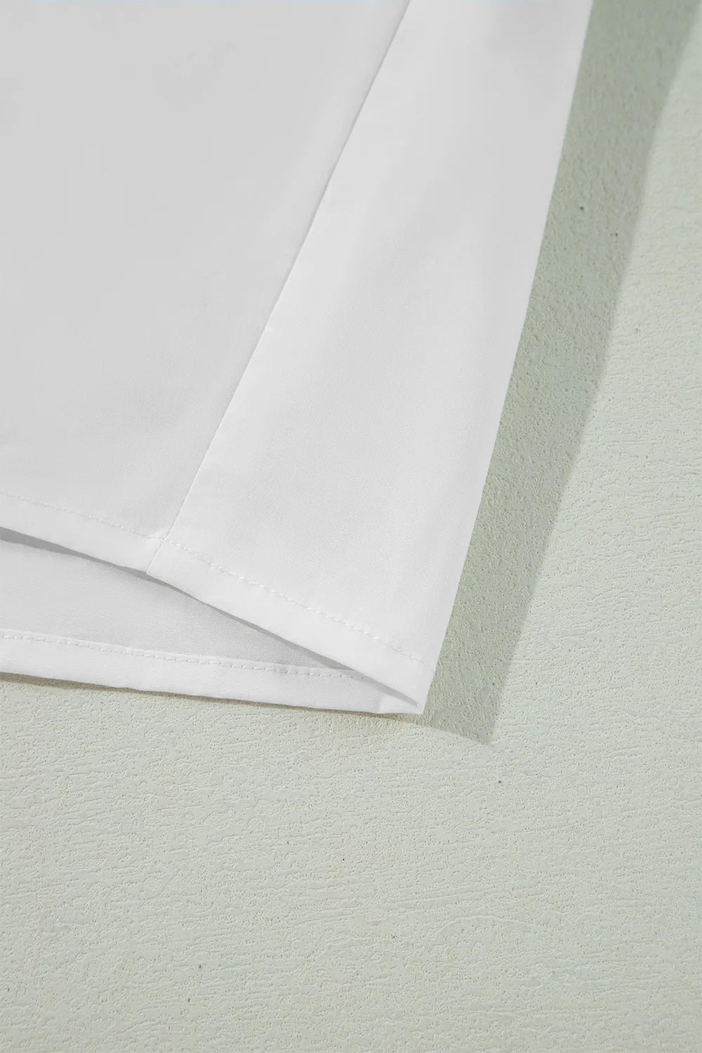 White cotton shirt with stitched hem, ribbon bowtie collar, flounce sleeves