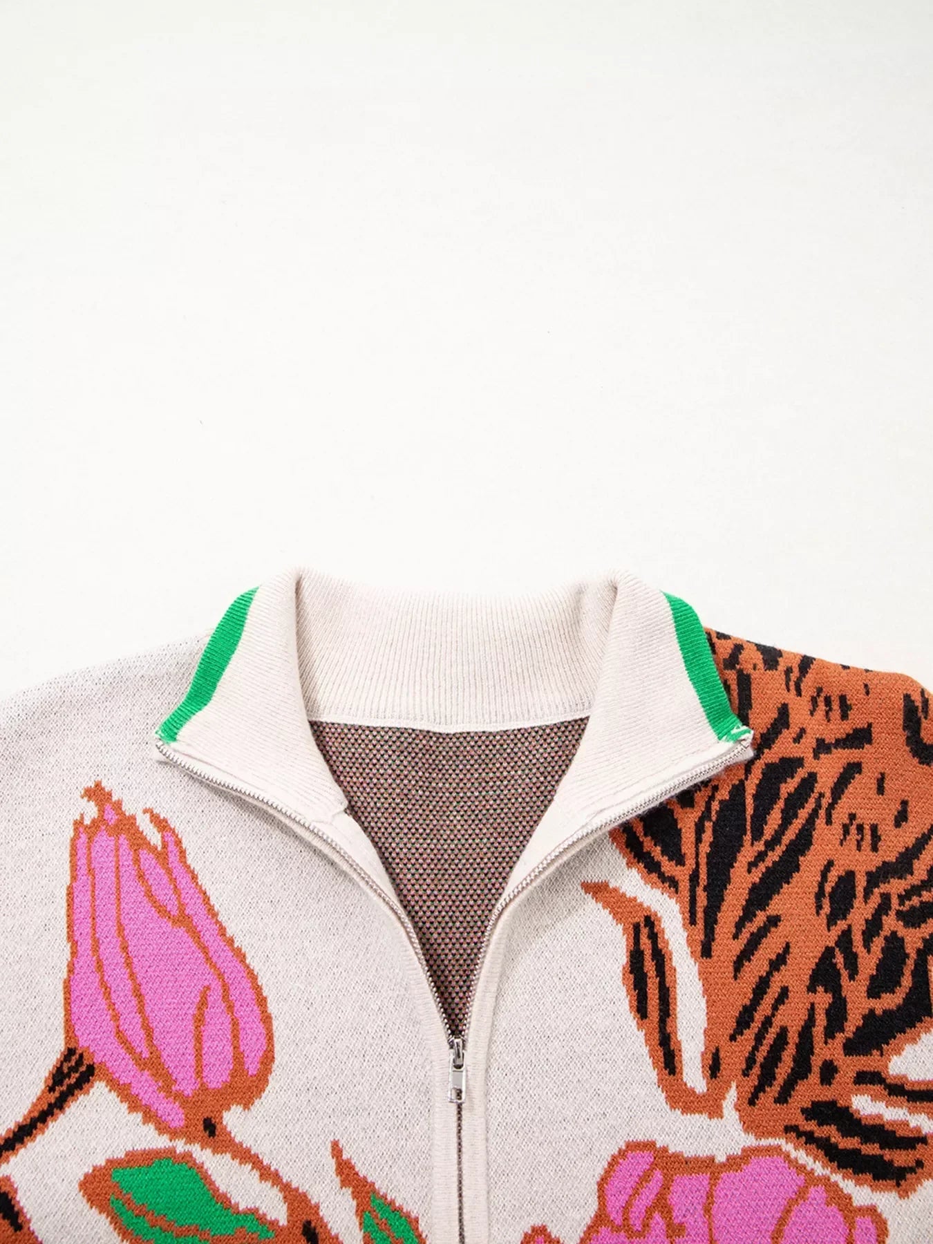 Floral knit quarter zip sweater with green accents and tiger stripes