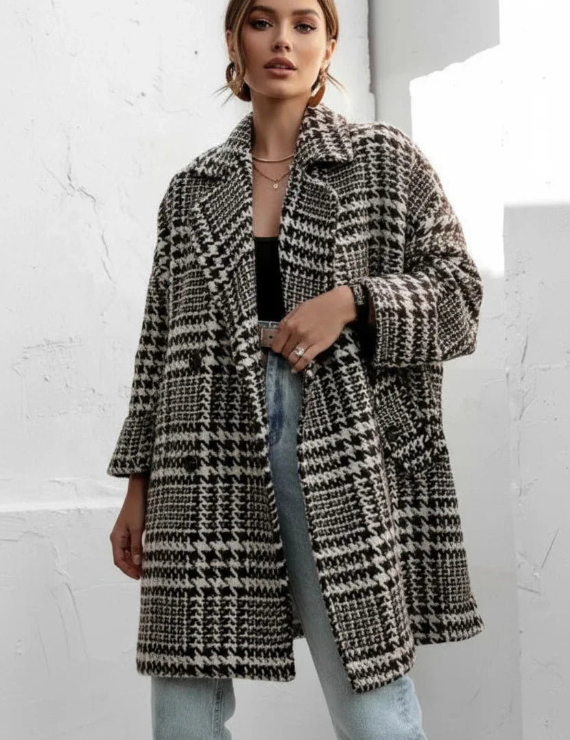 Black and white houndstooth collared long sleeve coat with oversized lapels and pockets