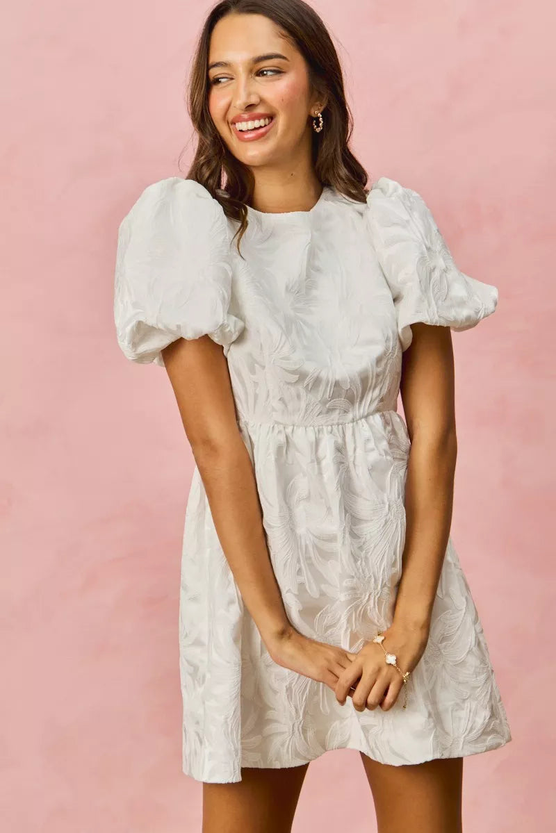 White textured mini dress with puff sleeves and gathered waist