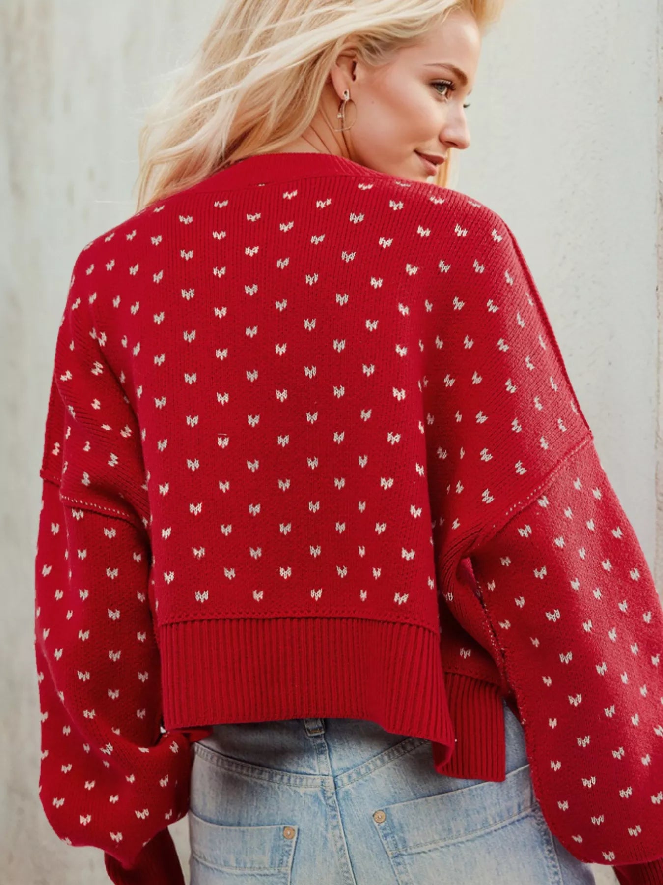 Red cropped knit Daverri sweater with white butterfly motifs