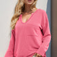 Pink ribbed knit V-neck long-sleeve top with striped front pocket