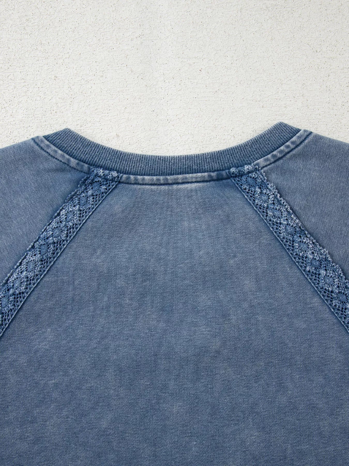 Blue denim sweatshirt with lace trim on raglan sleeves