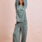 Cozy sage green ribbed loungewear set with cowl-neck top and wide-leg pants