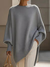 Light gray oversized knit poncho with batwing sleeves and ribbed cuffs
