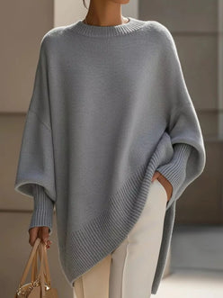 Light gray oversized knit poncho with batwing sleeves and ribbed cuffs