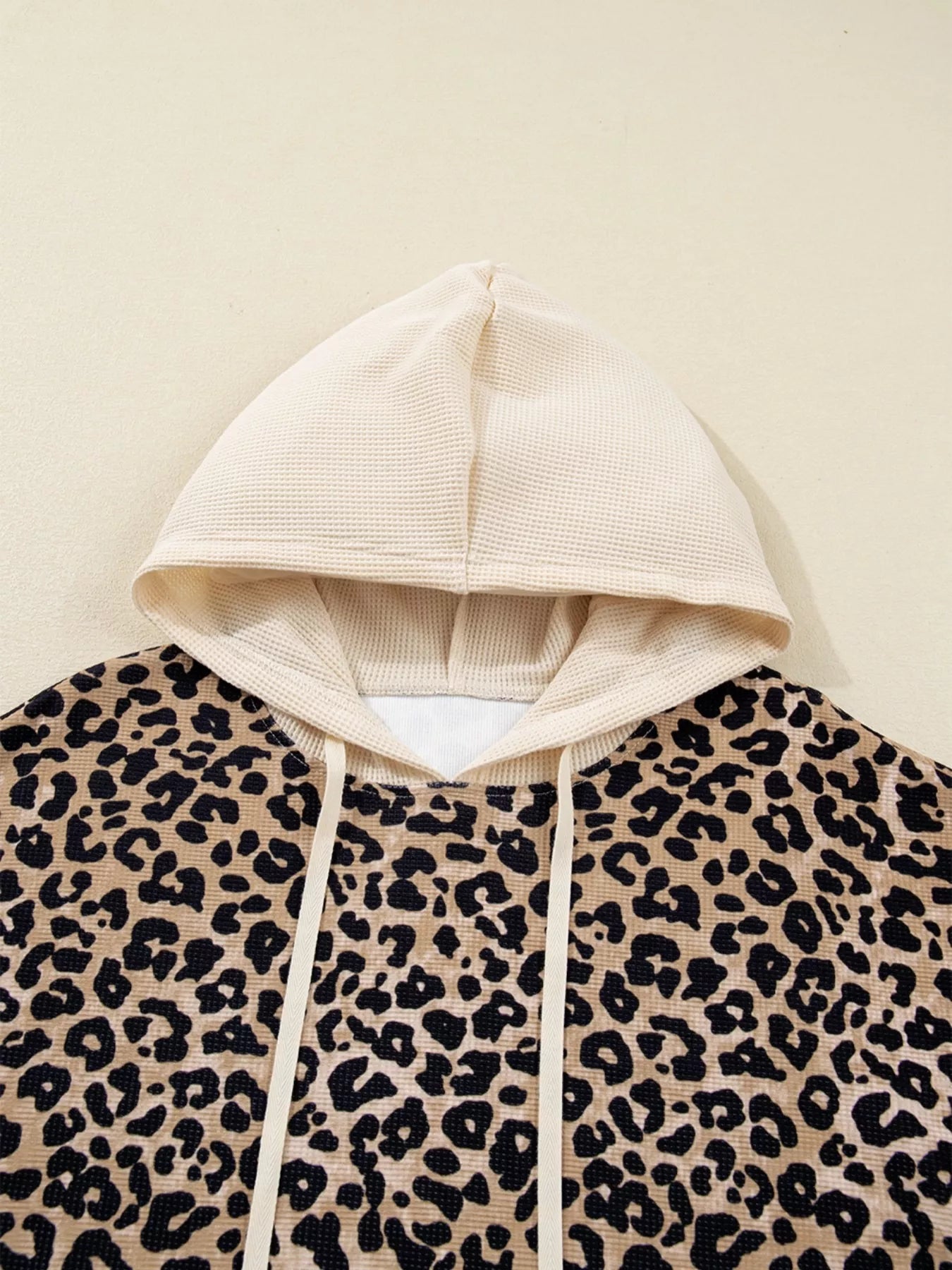 Leopard print long sleeve hoodie with cream hood, drawstrings and pocket