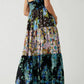 Floral tiered maxi dress with dark blue black base and vibrant pink teal yellow green print