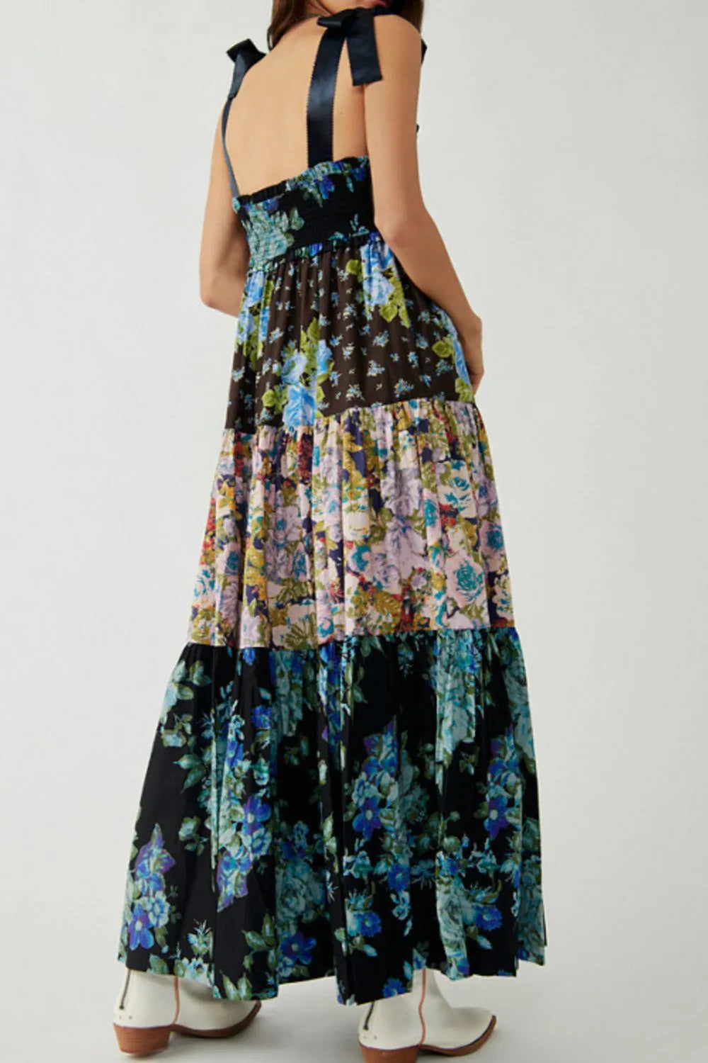 Floral tiered maxi dress with dark blue black base and vibrant pink teal yellow green print