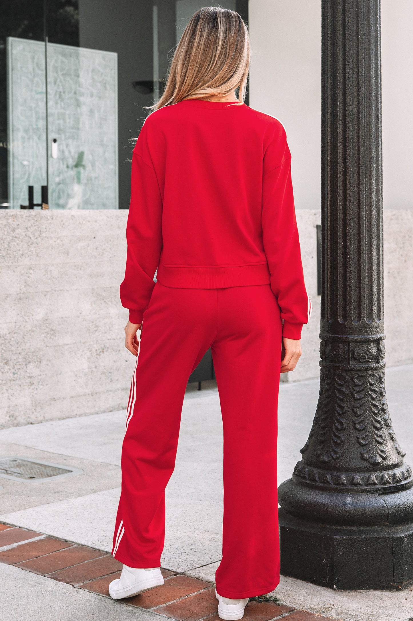 Women’s red crewneck sweatshirt and sweatpants set with white side stripes