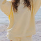 Soft pale yellow oversized sweatshirt with relaxed fit and ribbed cuffs