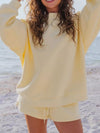 Soft pale yellow oversized sweatshirt with relaxed fit and ribbed cuffs