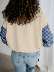 Beige and blue checkered half-zip sweatshirt with pocket sleeve detail