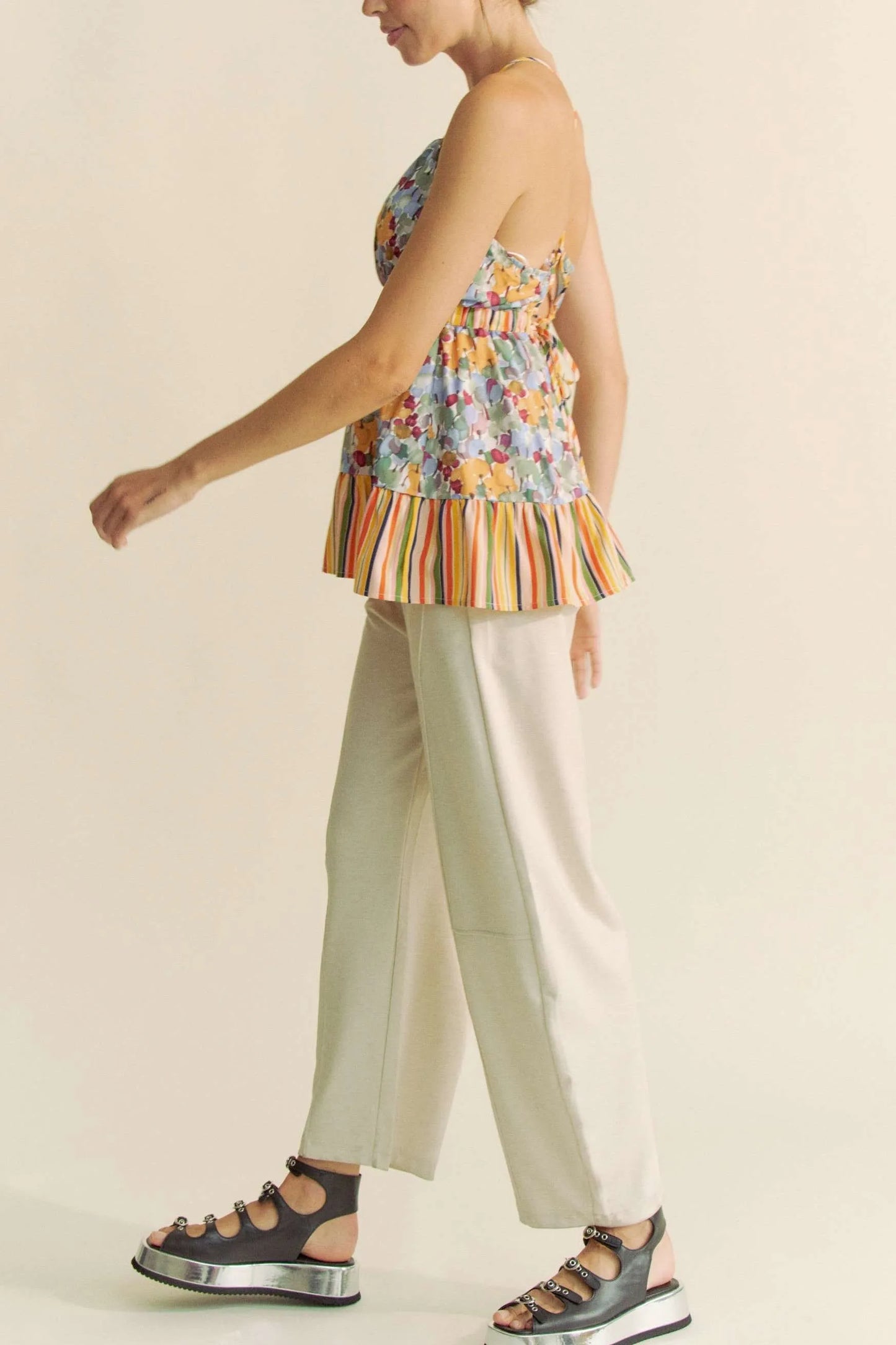 Woman in Davi & Dani floral smocked sleeveless ruffle back tie top