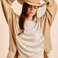 Beige suede cowboy hat with braided leather band on BiBi top