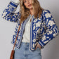 Blue and white floral print bomber jacket with striped trim and buttoned cuffs