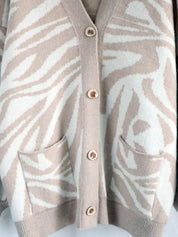 Beige and white zebra print button-up cardigan with gold buttons