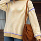 Cozy striped round neck long sleeve sweater in pale yellow, white, and purple trim