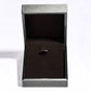 Black jewelry box with a silver lid on a white background