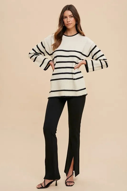 Black and white striped Annie Wear sweater with bell sleeves and side slits