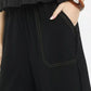 Umgee Linen Frayed Side Pocket Wide Leg Pants with black wide-leg design and white pocket stitching