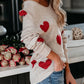 Beige off-shoulder knit sweater with red heart appliques