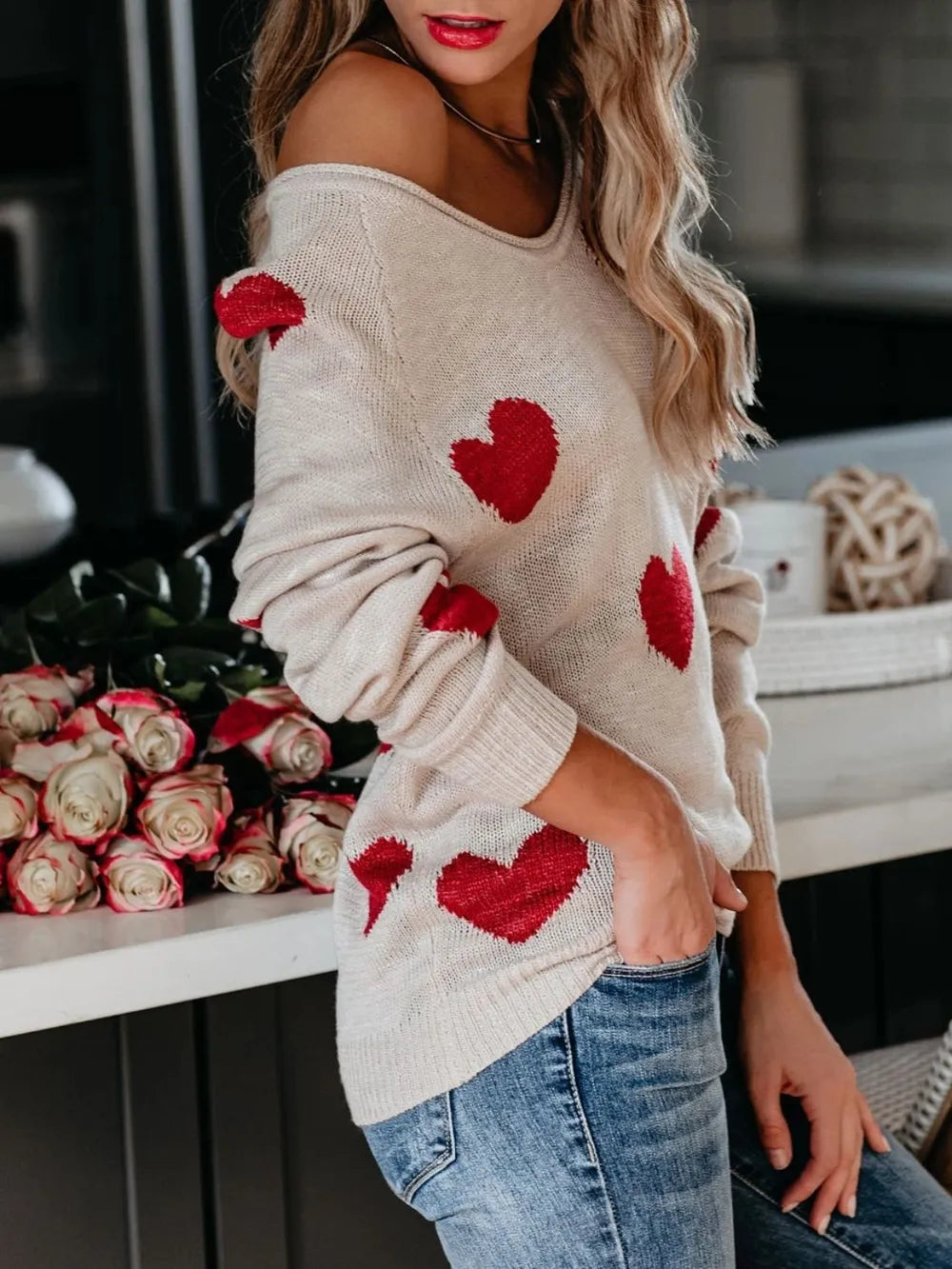 Beige off-shoulder knit sweater with red heart appliques