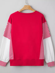 Red and white striped sweater with balloon patchwork sleeves on wooden hanger