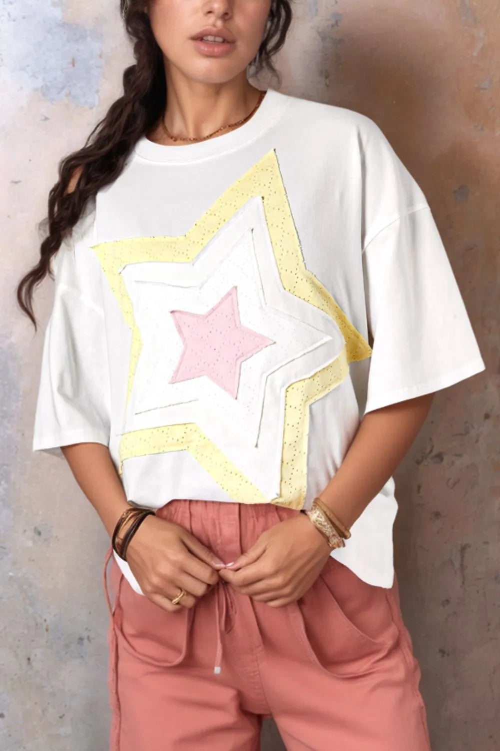 White oversized drop shoulder tee with layered star graphic in yellow and pink