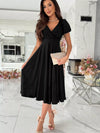 Black surplice v-neck midi dress with short puffed sleeves and flared skirt