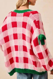 Oversized red and white checkered Christmas cardigan with green trim