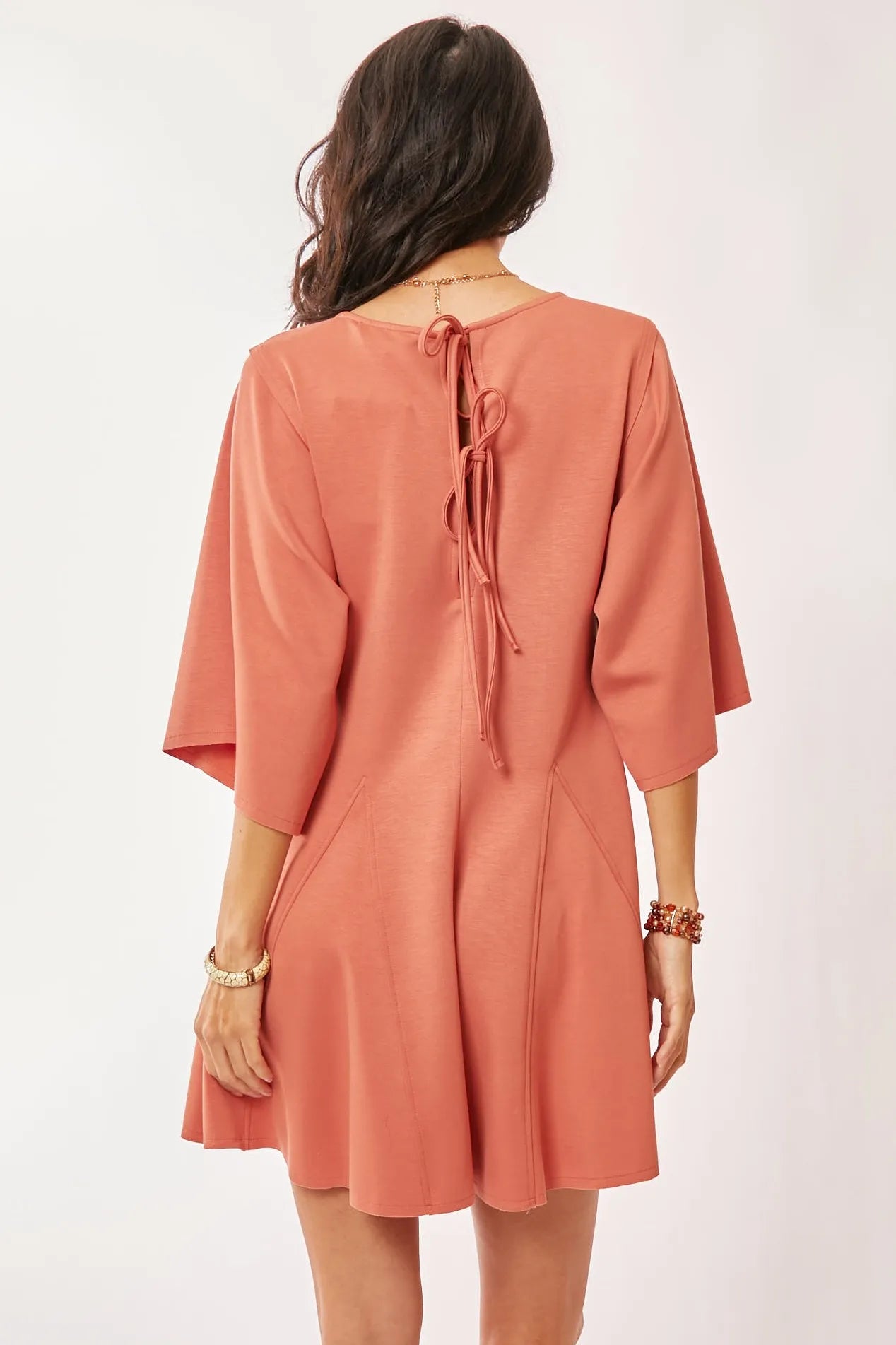Davi & Dani soft peach draped sleeve ties back skort romper