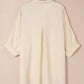 Cream-colored womens oversized 3/4 sleeve button-up blouse